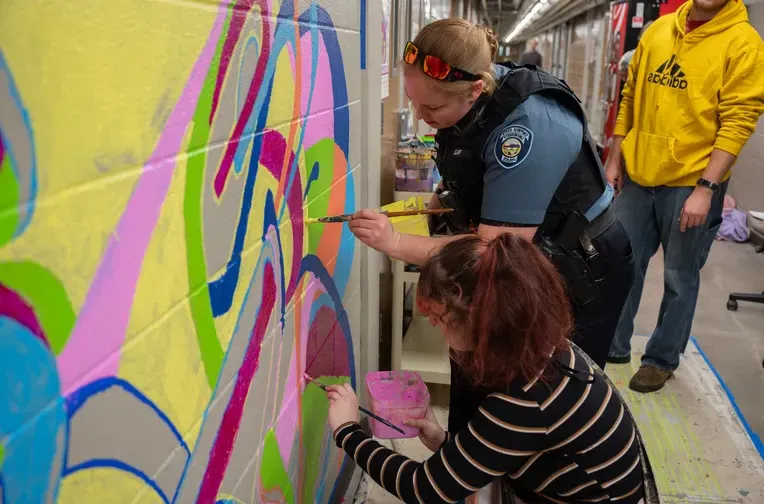 Officer painting mural